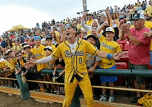 a man in a yellow baseball uniform with the number 8 on it