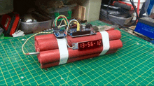 a red bomb with a digital display that says 13 56 12 on it