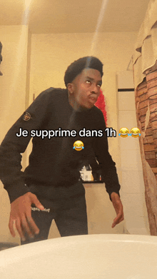 a young man standing in front of a sink with the words je supprime dans 1h on the bottom