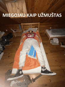 a person laying on a bed with the words " miegojau kaip uzmuistas " above them