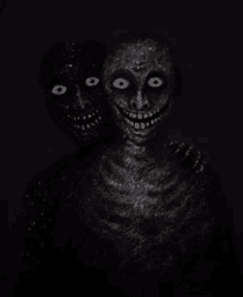 a black and white photo of a skeleton with two faces , one of which is smiling .