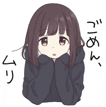 a girl in a black hoodie is sitting down with her hands on her chin .