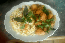 a white plate topped with rice and chicken curry