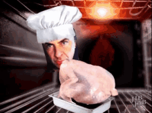 a man wearing a chef 's hat is holding a chicken