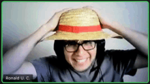 a man wearing a straw hat and glasses is on a video call with the name ronald u.c.