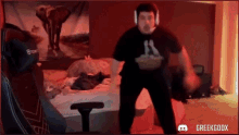 a man wearing headphones is dancing in a room with greekgodx written on the bottom