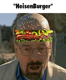 a man with glasses and a beard is wearing a hamburger on his head .