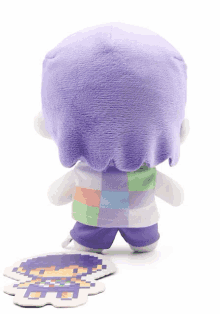 a stuffed toy with purple hair and a purple shirt and shorts