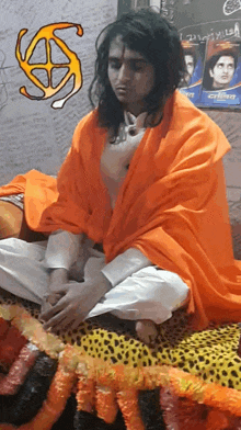 a man in an orange robe sits on a bed in front of a gillette ad