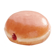 a doughnut with a strawberry filling is sitting on a white surface