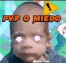 a close up of a baby 's face with the words pvp o miedo written above it .