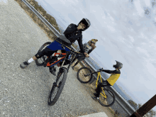 a man wearing a helmet is riding a bike on a gravel path