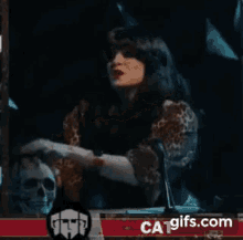 a woman is holding a skull and says i would love that ca-gifs.com