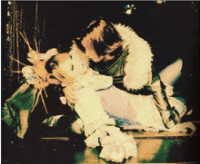 a woman in a white dress is laying on a man 's chest