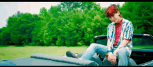 a pixel art of a man sitting in a car