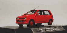 a model of a red daihatsu mira turbo on display