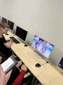 a group of people are playing a game on a dell monitor