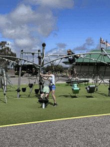 a boy and a girl are playing in a playground