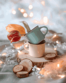 two coffee cups are stacked on top of each other on a wooden slice