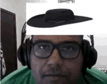 a man wearing glasses and headphones has a picture of a hat on his forehead