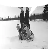 a person is upside down in the snow with their feet up