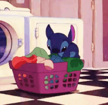 a cartoon character is sitting in a laundry basket .