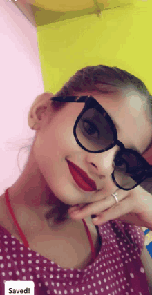 a woman wearing sunglasses and red lipstick has the word saved at the bottom of her photo