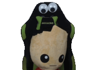 a black and green akracing gaming chair with a stuffed animal on it