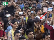 a crowd of people are gathered in front of a mtv sign