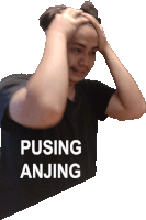 a man in a black shirt has his hands on his head and the words pusing anjing written on the bottom