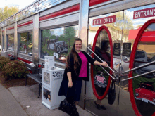 a woman stands in front of a diner that has an exit only sign on the door