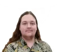 a man with long hair and a beard wears a hawaiian shirt