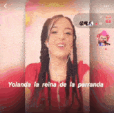 a woman singing yolanda la reina de la parranda on a phone