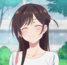 a girl with brown hair and a white shirt is smiling with her eyes closed