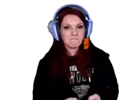 a woman wearing headphones and a shirt that says " the wolves "