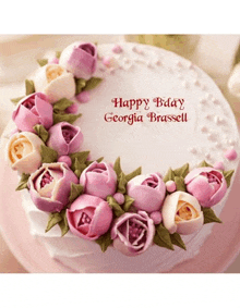 a birthday cake with pink and white flowers and the words happy bday georgia brassell on it