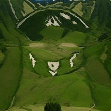 a valley with a river running through it and a mountain in the background