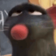 a close up of a black cartoon rat with a red nose .