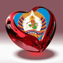 a red heart shaped object with a picture of a man in a crown on it