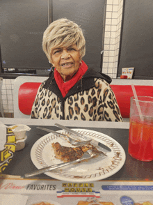 a woman sits at a table with a plate of food and a menu that says waffle house on it