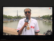 snoop dogg is wearing a white usa jersey and holding a microphone