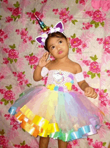 a little girl dressed as a unicorn with a unicorn headband