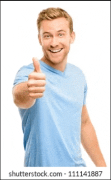 a young man in a blue shirt is giving a thumbs up