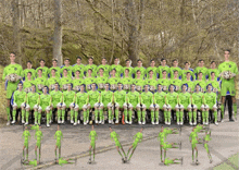 a soccer team is posing for a team photo and they are all wearing green jerseys with the word soccer on the front