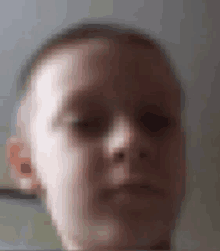 a blurry picture of a young boy 's face .