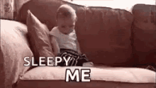 a baby is sitting on a couch with the words `` sleepy me '' .