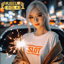 a woman wearing a shirt that says slot holding sparklers