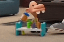 a toy monkey is sitting on top of a toy table .