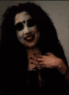 a woman with a scary makeup on her face smiles for the camera