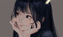 a girl with long black hair and glasses is holding her hand to her chin .